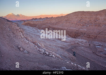 walk, walking, trek, trekking, hiker, man, Moon valley, near San Pedro de Atacama, and salt deposited on the ground, Atacama desert. Chile Stock Photo