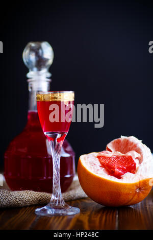 sweet grapefruit alcoholic cordial in the decanter with a glass Stock Photo