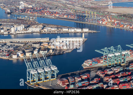 Los Angeles, California, USA - August 16, 2016:  Afternoon aerial view of Los Angeles harbor berths, cranes and containers. Stock Photo