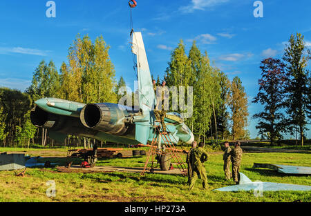 The jet fighter SU-27 is set by a monument in the territory of the Vitebsk aeroclub. Assembly of the SU-27 aircraft - installation of the  tails. Stock Photo