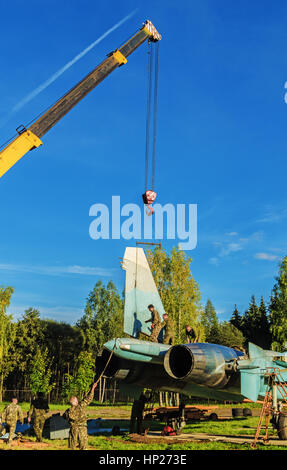 The jet fighter SU-27 is set by a monument in the territory of the Vitebsk aeroclub. Assembly of the SU-27 aircraft - installation of the  tails. Stock Photo