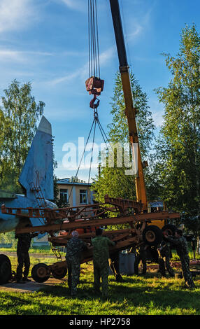 Transportation on the tow of the disassembled airplane SU-27.The airplane is set by a monument in the territory of the Vitebsk aeroclub. Stock Photo