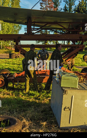 The jet fighter SU-27 is set by a monument in the territory of the Vitebsk aeroclub. Assembly of the SU-27 plane - installation of wings. Stock Photo