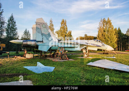 The jet fighter SU-27 is set by a monument in the territory of the Vitebsk aeroclub. Assembly of the SU-27 plane - installation of wings. Stock Photo