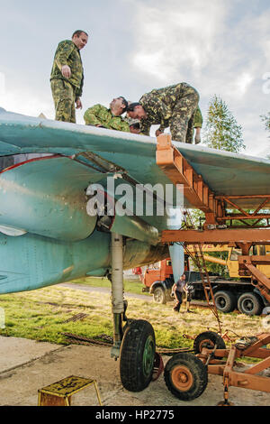 The jet fighter SU-27 is set by a monument in the territory of the Vitebsk aeroclub. Assembly of the SU-27 plane - installation of wings. Stock Photo