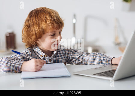 Hard working smart boy studying for his test Stock Photo