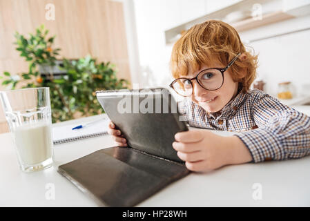 Funny smart boy using his tablet Stock Photo