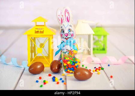 Milk chocolate easter bunny and chocolate eggs over white background Stock Photo