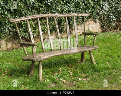 Rustic handmade wooden park bench seat, Ticknall, Derbyshire, England, UK Stock Photo