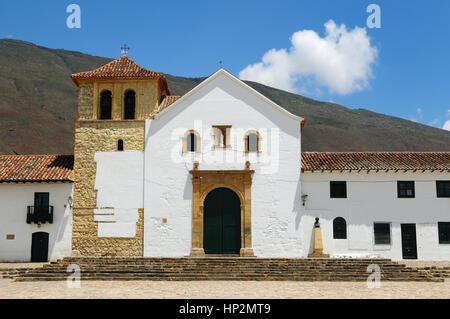 Beautiful white villa with shingle roofs hidden behind walls in colonial Villa de Leyva. Parish church on the plaza central, Colombia,