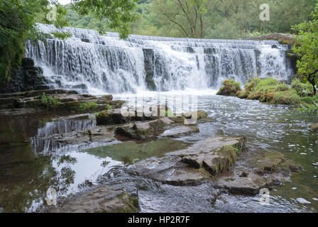 Derbyshire, UK - July 20 2014 - Man made waterfall Monsal Dale weir on the River Wye, Monsal Dale, Derbyshire, Peak District UK Stock Photo