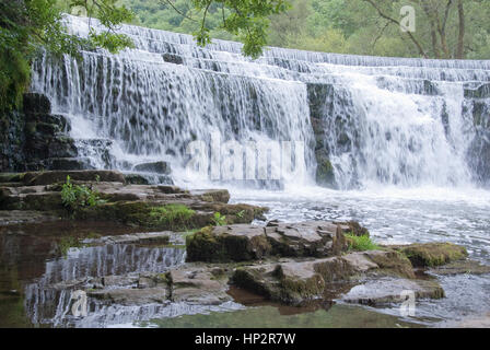 Derbyshire, UK - July 20 2014 - Man made waterfall Monsal Dale weir on the River Wye, Monsal Dale, Derbyshire, Peak District UK Stock Photo