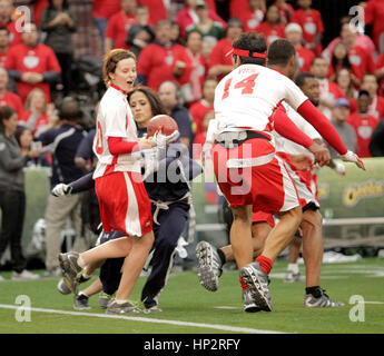 Sarah Ramos, left, runs with the ball at the Tazon Latino V flag football game at Super Bowl NFL Experience at the Dallas Convention Center on February 2, 2011 in Dallas, Texas. Photo by Francis Specker Stock Photo