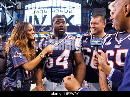 Singer Ciara, left, interviews New England Patriot players, Donald Thomas (64), Matt Kopa (68) and Nick McDonald (65) who shows off a Madonna bra at the Super Bowl XLVI Media Day in Indianapolis, Indiana on January 31, 2012. Francis Specker Stock Photo
