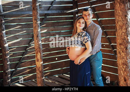 couple waiting for baby photo shoot in a wooden house Stock Photo