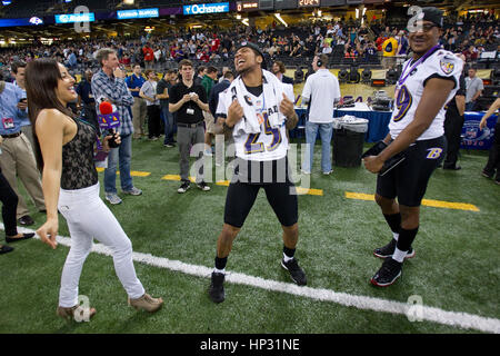 Johanna Pena Gutierrez a reporter with TV Azteca Noreste, left, dances with Baltimore Ravens' Asa Jackson, center, and D.J. Bryant at the Super Bowl XLVII Media Day on January 29, 2013, in New Orleans, Louisiana. Photo by Francis Specker Stock Photo