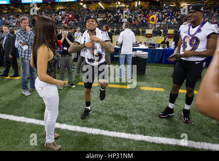 Johanna Pena Gutierrez a reporter with TV Azteca Noreste, left, dances with Baltimore Ravens' Asa Jackson, center, and D.J. Bryant at the Super Bowl XLVII Media Day on January 29, 2013, in New Orleans, Louisiana. Photo by Francis Specker Stock Photo