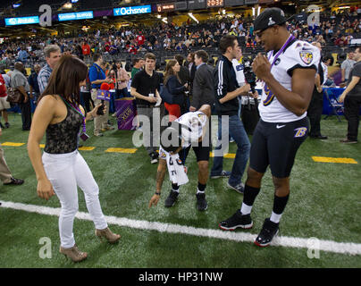 Johanna Pena Gutierrez a reporter with TV Azteca Noreste, left, dances with Baltimore Ravens' Asa Jackson, center, and D.J. Bryant at the Super Bowl XLVII Media Day on January 29, 2013, in New Orleans, Louisiana. Photo by Francis Specker Stock Photo