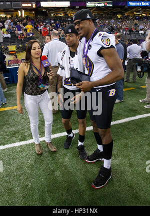 Johanna Pena Gutierrez a reporter with TV Azteca Noreste, left, interviews Baltimore Ravens' Asa Jackson, center, and D.J. Bryant at the Super Bowl XLVII Media Day on January 29, 2013, in New Orleans, Louisiana. Photo by Francis Specker Stock Photo