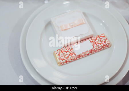 Gorgeous white dishes and tablecloth the wedding table. Stock Photo