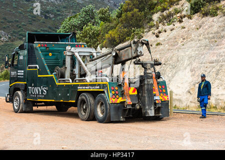 Toitskloof pass, South Africa - November 21, 2016: The driver of a heavy duty wrecker used for towing semi trucks is making a break before towing a la Stock Photo
