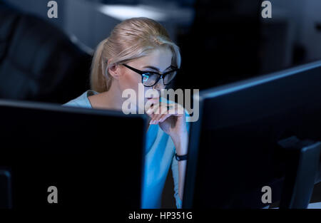 Confident hacker working on solving online password codes Stock Photo