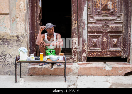 Man selling cigars and cafe, subsistence or survival shop,in Damas street, Habana Vieja district, La Habana, Cuba Stock Photo
