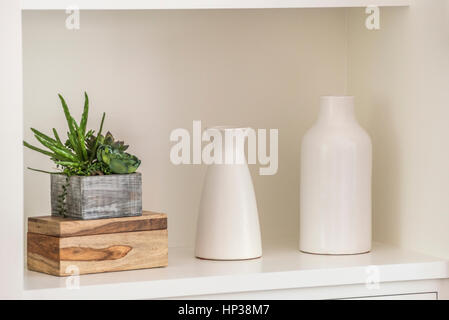 Two white vases and cactus plant in a small alcove. Stock Photo