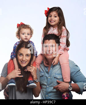 Portrait of happy family with two girls on shoulders isolated on white background Stock Photo