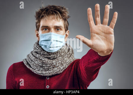 Stop - virus! Sick man in protective mask gesturing stop. Healthcare concept Stock Photo