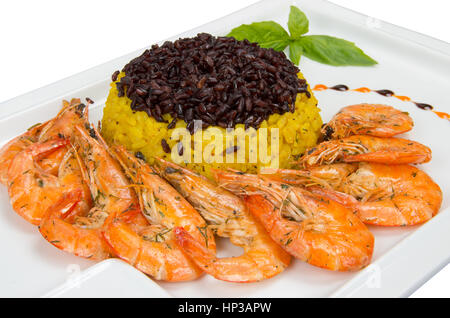 Sea gift. Shrimp with yellow rice and black. Stock Photo