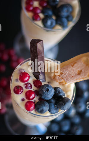 vanilla ice cream with berries of blueberry and currant, chocolate, biscuit Stock Photo