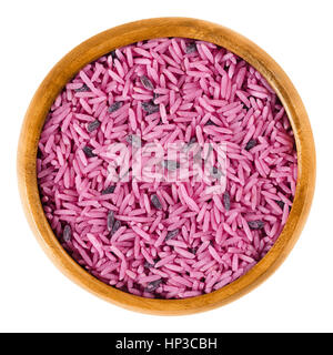 Glam Wedding Pink in a wooden bowl. Pink rice of lovers. Basmati and black rice colored with red beets, symbolizing crazy Bollywood weddings. Stock Photo