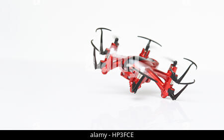 One red drone flying isolated on white background. Clsoe up of fly drone Stock Photo