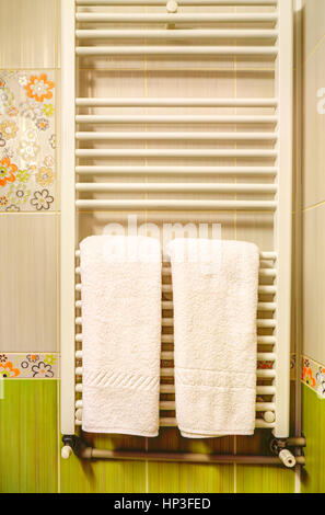 White towels on heater in a modern bathroom Stock Photo
