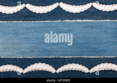 Luxury elegant frame made of white stucco plaster lying on denim. Copy space. View from above Stock Photo