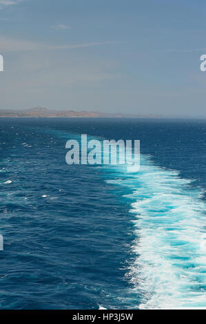 Cruise ship trace on blue sea on back. Fast going ship. Foam trace of boat Stock Photo