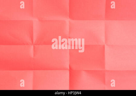 Red sheet of paper folded many times Stock Photo