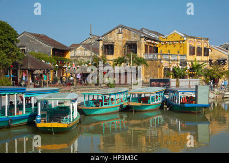 Tourist boats on Thu Bon River and historic buildings, Hoi An (UNESCO World Heritage Site), Vietnam Stock Photo