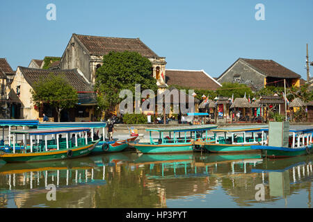 Tourist boats on Thu Bon River and historic buildings, Hoi An (UNESCO World Heritage Site), Vietnam Stock Photo