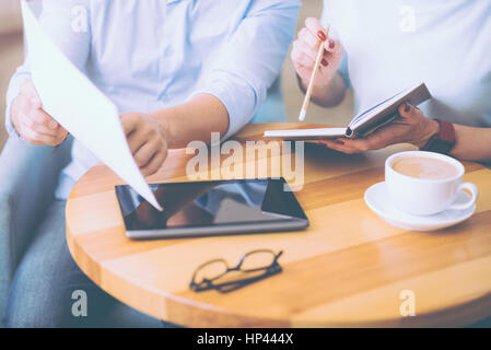 PLeasant colleagues discussing business matters Stock Photo