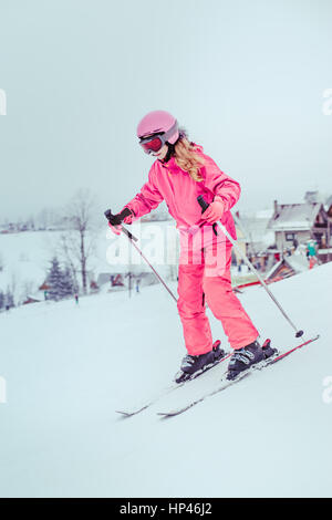 Girl skiing down the slope Stock Photo