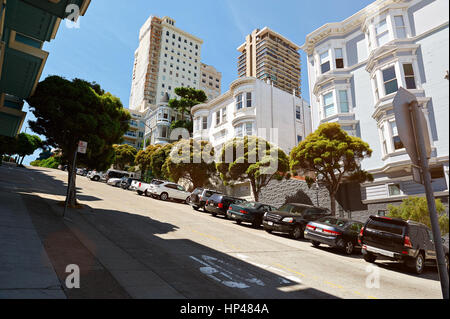 Street in San francisco with road on high hill. Cars parked in modern street Stock Photo