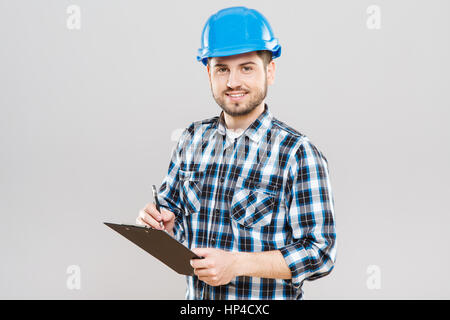 Builder writing on tablet Stock Photo