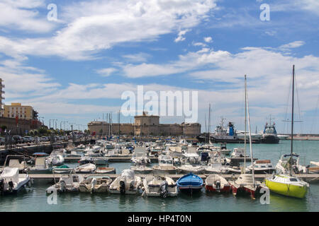 Boats in the marina with the castle in the background in Civitavecchia, Lazio, Italy Stock Photo