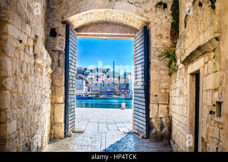 Old city gate in town Trogir, european travel resorts in summertime. Stock Photo