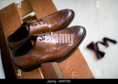 shoes stacked in composition on a black desk Stock Photo