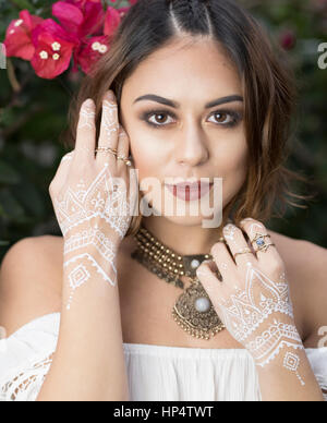 Bohemian woman with white henna on hands Stock Photo