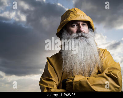 Fisherman with yellow jacket Stock Photo