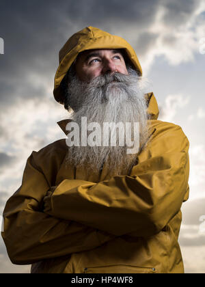Fisherman with yellow jacket Stock Photo
